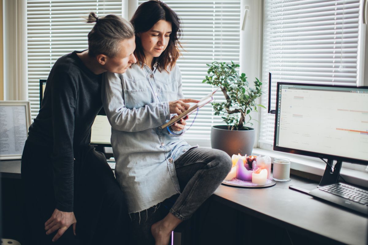 Two colleagues working through a task at a computer